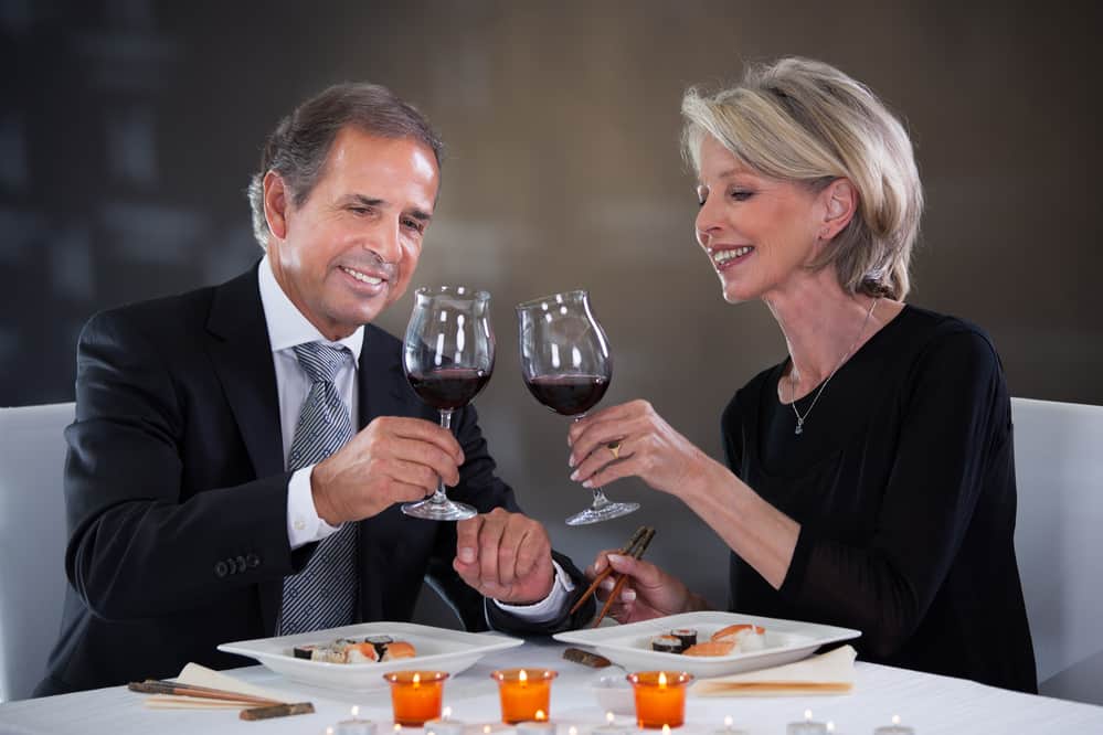 couple toast with wine and candles romantic dinner