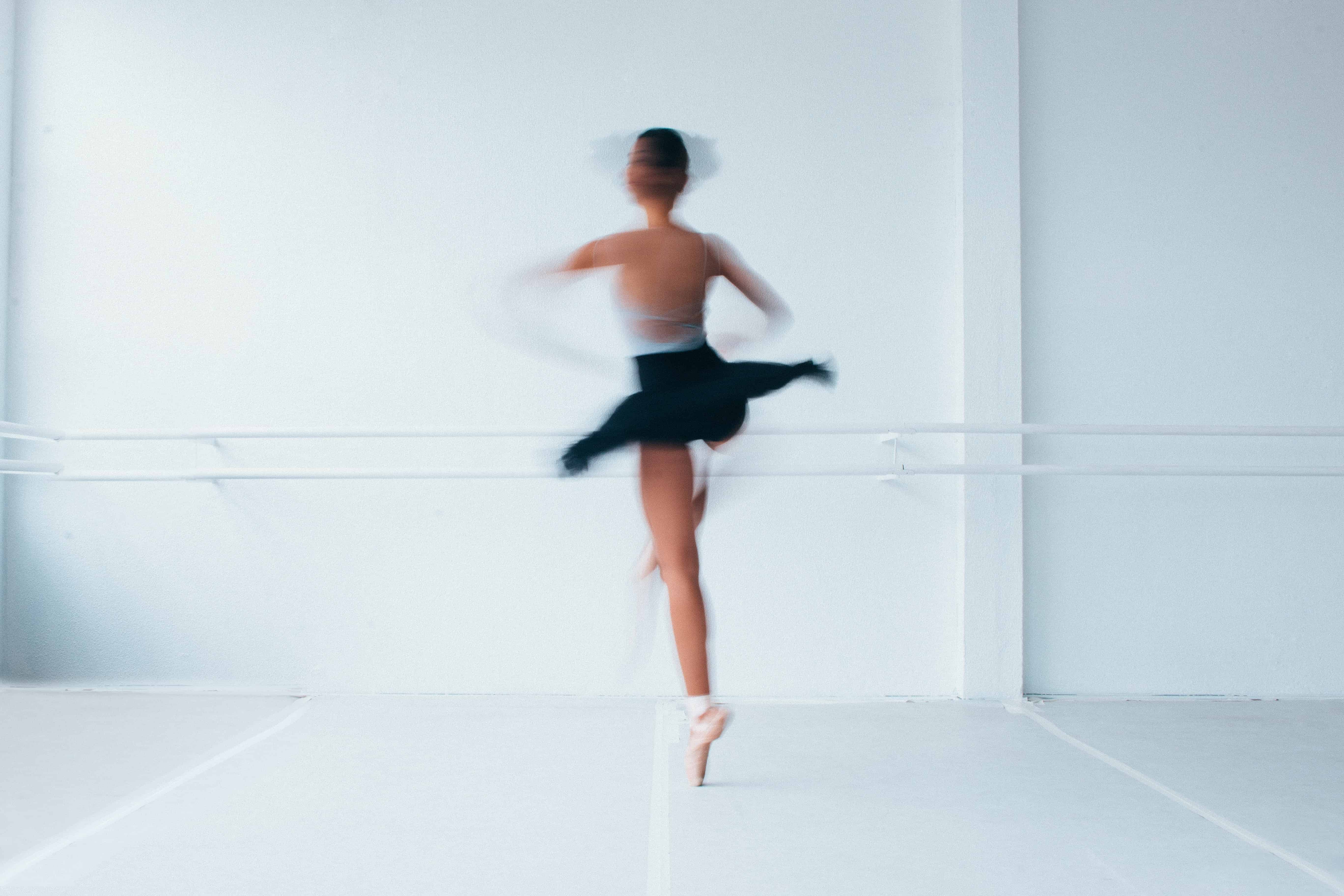 Spinning Ballerina in white studio