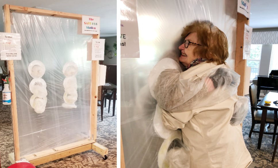 Seniors hugging during Covid-19 pandemic with sanitary hug station