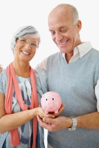 seniors holding piggy bank smiling