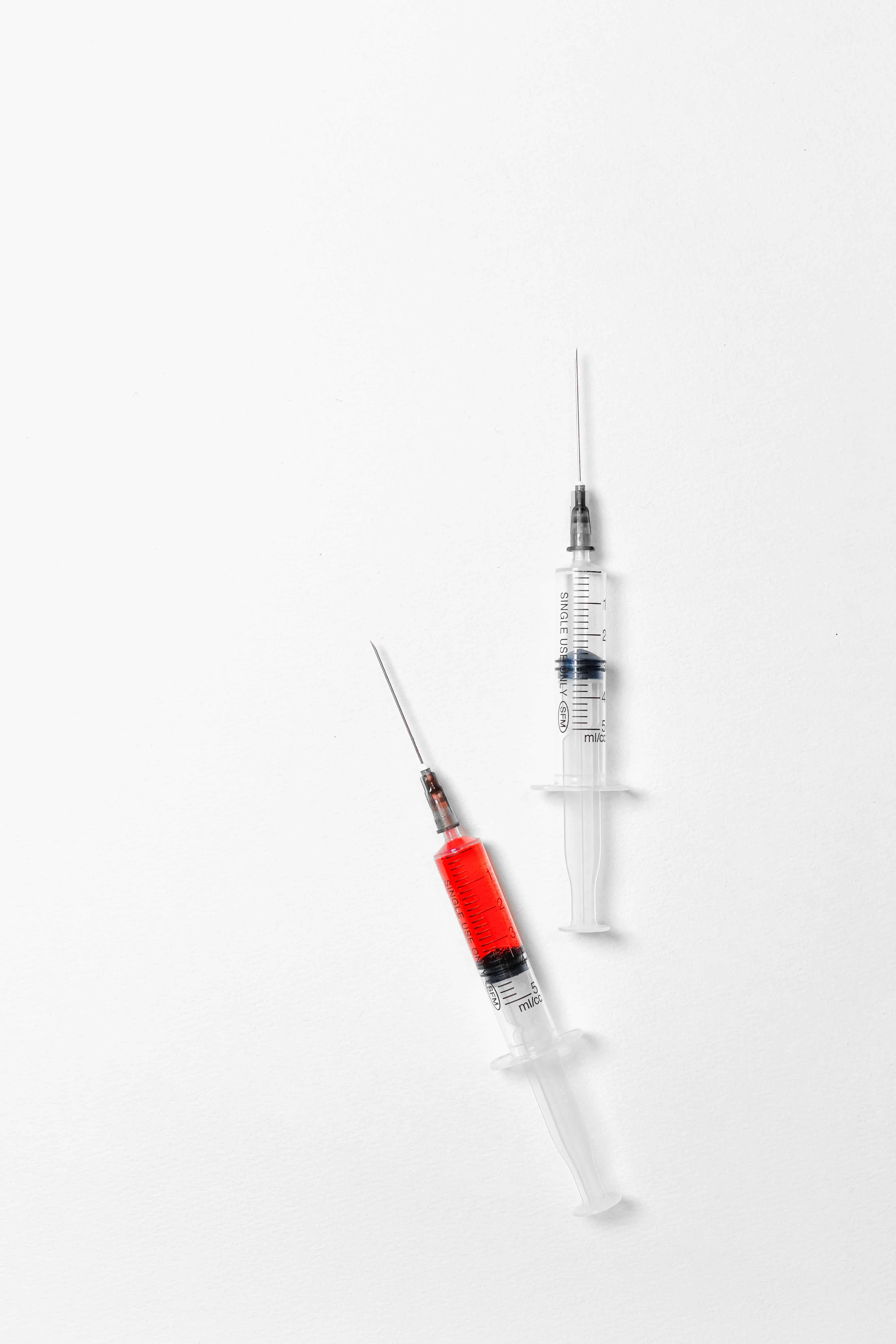 red and clear syringe vaccine